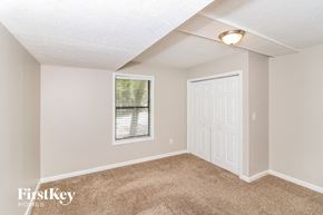 Kennesaw house for rent - a bedroom with carpet and a white door and a window