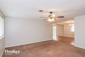 Marietta house for rent - A spacious room with a ceiling fan and light fixture.