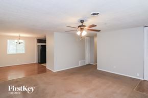 Marietta house for rent - A spacious room with a ceiling fan and lighting fixture.