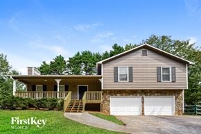 Dallas house for rent - a house with two garage doors in front of it