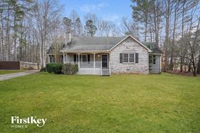Dallas house for rent - a small white house with a yard and a white fence
