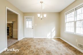 Dallas house for rent - the dining room of a home with a fireplace and a chandelier