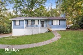 Kennesaw house for rent - a small blue and white house with a yard and a sidewalk