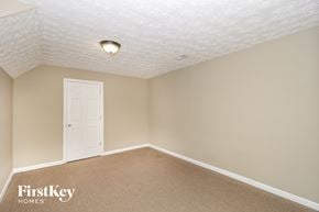 Kennesaw house for rent - a bedroom with a white door and beige walls and a carpet