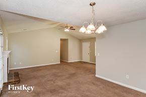 Powder Springs house for rent - A spacious room with a chandelier and a fireplace on the left side.