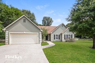 Powder Springs house for rent - a gray and with a driveway and a garage door
