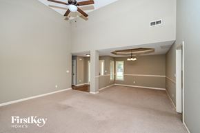 Powder Springs house for rent - a living room with a ceiling fan and a large empty room