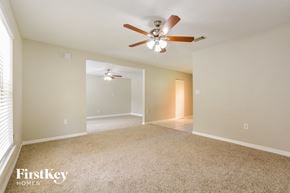 Cocoa house for rent - the spacious living room with ceiling fan and carpeting