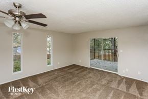 Flower Mound house for rent - A room with a carpet floor and a ceiling fan.