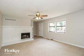Marietta house for rent - a living room with a ceiling fan and a fireplace