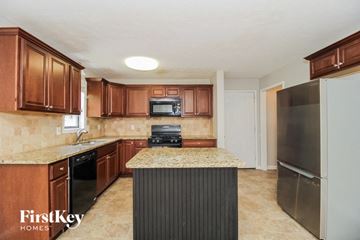 Marietta house for rent - a kitchen with a counter top and a refrigerator