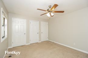 Marietta house for rent - a bedroom with three doors and a ceiling fan