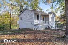 Hiram house for rent - a white house with a white porch and trees