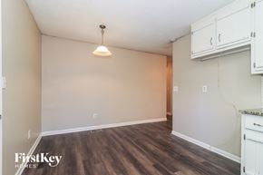 Hiram house for rent - the living room of an apartment with white cabinets and wood flooring