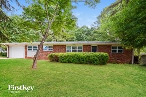 Marietta house for rent - a brick house with a lawn in front of it