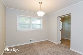 Marietta house for rent - a bedroom with a large window and a door to a closet