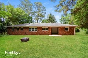 Marietta house for rent - front view of a red brick house with a grassy yard