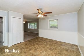 Marietta house for rent - the living room and dining room of a house with a ceiling fan
