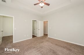 Lawrenceville house for rent - A spacious room with a ceiling fan and carpeted floor.