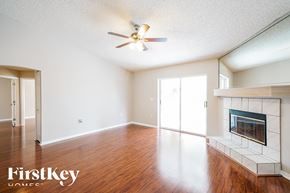 Lakeland house for rent - a living room with a fireplace and a ceiling fan