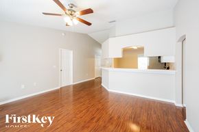 Lakeland house for rent - an empty living room with hardwood flooring and a ceiling fan