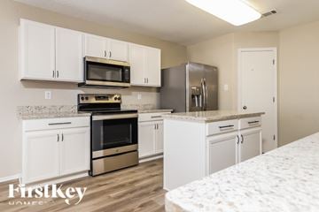 New Braunfels house for rent - A kitchen with white cabinets and appliances.