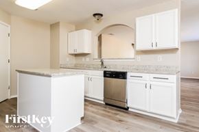 New Braunfels house for rent - A kitchen with white cabinets and a stainless steel dishwasher.