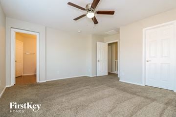 Surprise house for rent - a living room with carpet and a ceiling fan