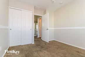 Surprise house for rent - a bedroom with two closets and a carpeted floor