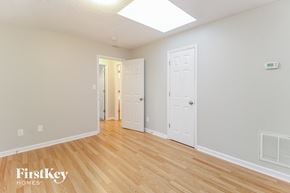 High Point house for rent - the living room of a house with wood floors and a white door