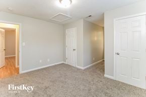 High Point house for rent - a bedroom with two doors and a carpeted floor