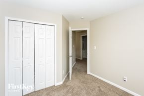 Charlotte house for rent - a bedroom with two closets and a hallway to a bathroom
