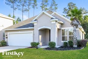 Jacksonville house for rent - a white house with a palm tree in front of it