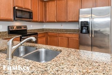 Jacksonville house for rent - a kitchen with granite counter tops and stainless steel appliances