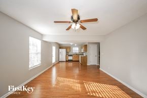 Indianapolis house for rent - an empty living room and kitchen with a ceiling fan