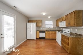 Indianapolis house for rent - a kitchen with wooden cabinets and white appliances