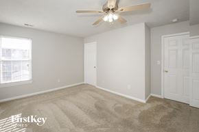 Indianapolis house for rent - a bedroom with carpet and a ceiling fan