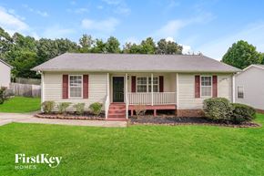 High Point house for rent - A small house with a red door and a porch.