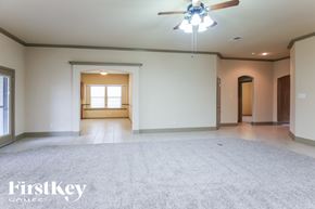 Burleson house for rent - A spacious room with a ceiling fan and a window.