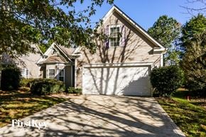 Charlotte house for rent - A house with a garage and a driveway is shown in the image.