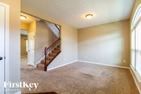 Morrow house for rent - A room with a carpeted floor and a staircase leading to the upper level.