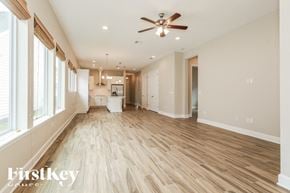 St Augustine house for rent - A spacious room with wooden flooring and a ceiling fan.