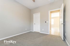Buckeye house for rent - a bedroom with a door to the bathroom and a carpeted floor
