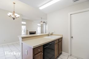 Oviedo house for rent - a kitchen with a sink and a door to a living room