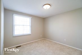 Batavia house for rent - a bedroom with white carpet and a window