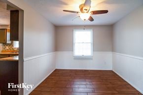 Batavia house for rent - an empty dining room with a ceiling fan and a window