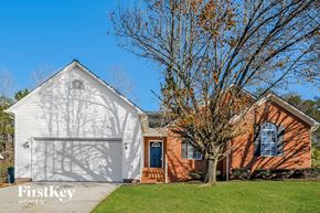Thomasville house for rent - a white and red brick house with a white garage door