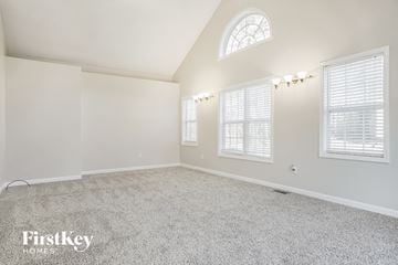 Thomasville house for rent - a spacious living room with white carpet and a window