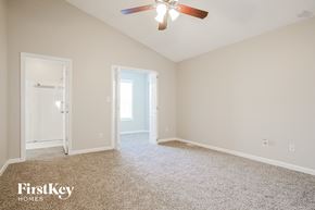 Thomasville house for rent - a bedroom with carpet and a ceiling fan