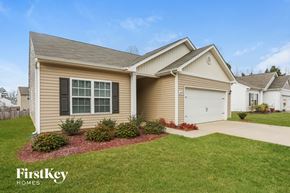 Charlotte house for rent - A house with a garage and a driveway is shown.